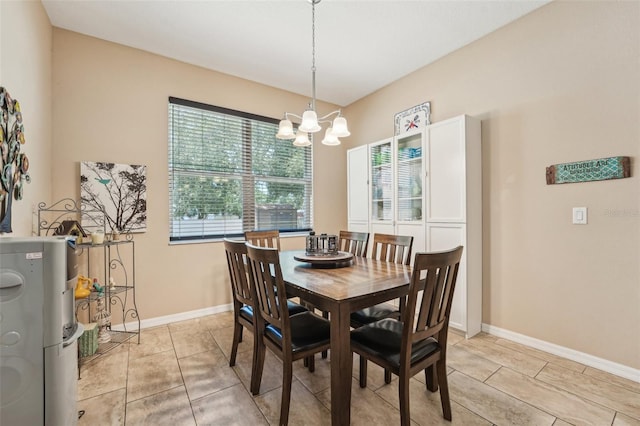 9917 Prevatt St, Gibsonton, FL 33534 - dining room with a chandelier, light tile patterned floors, and baseboards