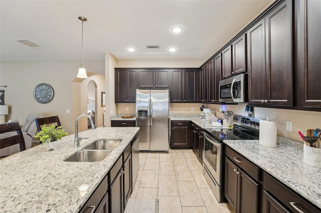 9917 Prevatt St, Gibsonton, FL 33534 - kitchen featuring stainless steel appliances, a sink, dark brown cabinetry, and recessed lighting