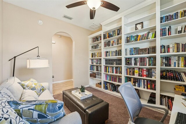 9917 Prevatt St, Gibsonton, FL 33534 - sitting room featuring arched walkways, a ceiling fan, baseboards, and carpet floors