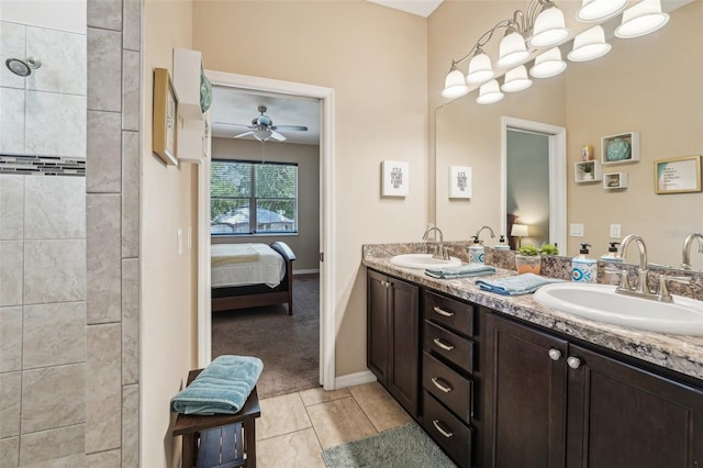 9917 Prevatt St, Gibsonton, FL 33534 - ensuite bathroom with a ceiling fan, double vanity, baseboards, tile patterned flooring, and a tile shower