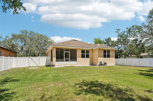 9917 Prevatt St, Gibsonton, FL 33534 - rear view of property featuring stucco siding, a gate, and a sunroom