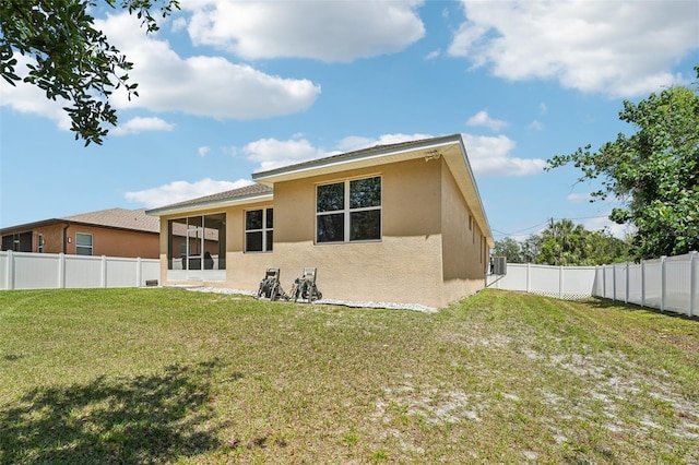 9917 Prevatt St, Gibsonton, FL 33534 - back of house featuring stucco siding and a sunroom