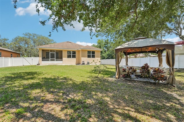 9917 Prevatt St, Gibsonton, FL 33534 - back of house featuring a gazebo and stucco siding