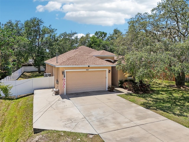 9917 Prevatt St, Gibsonton, FL 33534 - view of front of house with stucco siding, concrete driveway, a garage, and a shingled roof