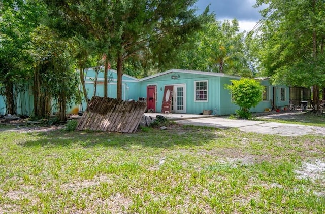 view of front of property featuring french doors and a front yard