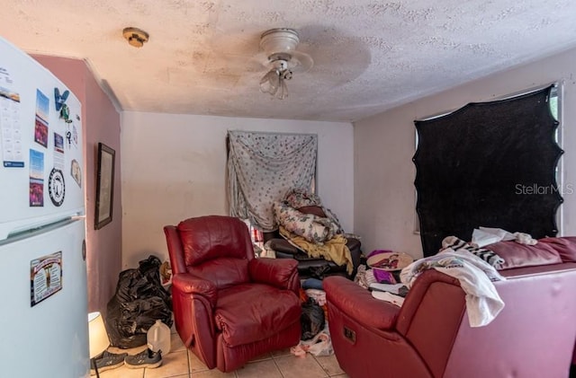 sitting room with light tile patterned floors and a textured ceiling