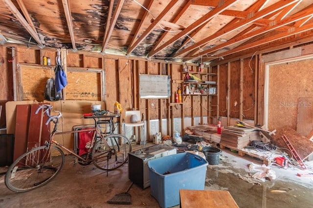 misc room with concrete flooring and a workshop area