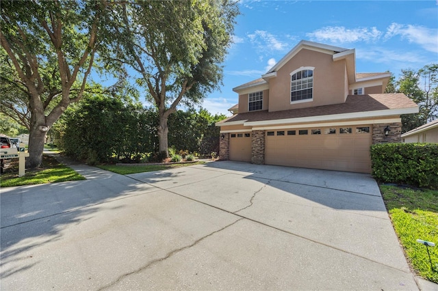 17809 Sandpine Trace Way, Tampa, FL 33647 - traditional-style home with a garage, driveway, stucco siding, and stone siding
