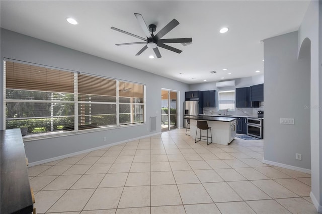 17809 Sandpine Trace Way, Tampa, FL 33647 - kitchen featuring stainless steel appliances, a breakfast bar, ceiling fan, a sink, and recessed lighting