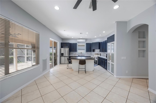 17809 Sandpine Trace Way, Tampa, FL 33647 - kitchen featuring appliances with stainless steel finishes, a breakfast bar, ceiling fan, arched walkways, and recessed lighting