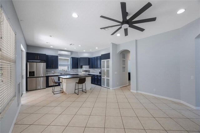 17809 Sandpine Trace Way, Tampa, FL 33647 - kitchen featuring stainless steel refrigerator with ice dispenser, a sink, arched walkways, a breakfast bar, and a ceiling fan