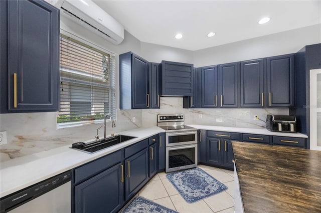 17809 Sandpine Trace Way, Tampa, FL 33647 - kitchen featuring stainless steel appliances, a sink, a wall unit AC, blue cabinetry, and backsplash