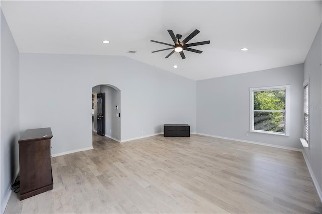 17809 Sandpine Trace Way, Tampa, FL 33647 - unfurnished living room with arched walkways, a ceiling fan, vaulted ceiling, light wood-type flooring, and recessed lighting