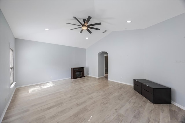 17809 Sandpine Trace Way, Tampa, FL 33647 - unfurnished living room with ceiling fan, arched walkways, light wood finished floors, lofted ceiling, and baseboards