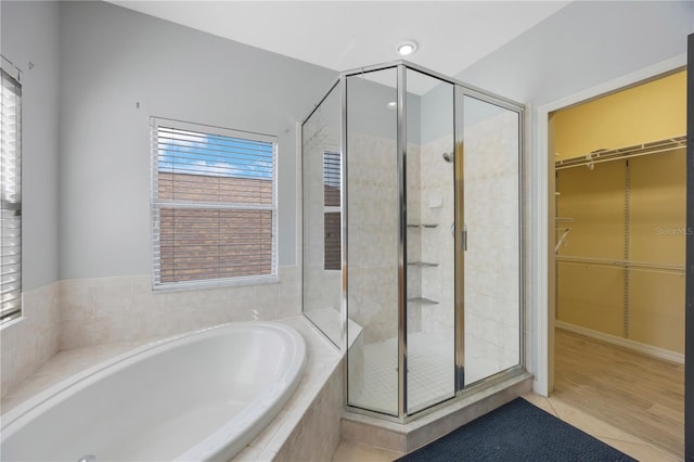 17809 Sandpine Trace Way, Tampa, FL 33647 - full bathroom with a stall shower, a garden tub, a spacious closet, and healthy amount of natural light