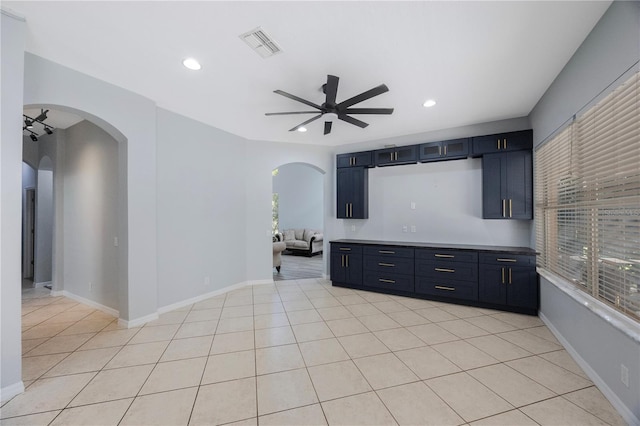 17809 Sandpine Trace Way, Tampa, FL 33647 - unfurnished living room featuring a ceiling fan, arched walkways, recessed lighting, light tile patterned floors, and baseboards