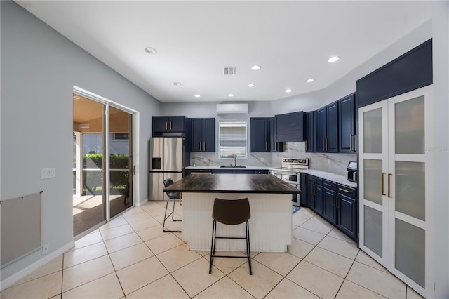 17809 Sandpine Trace Way, Tampa, FL 33647 - kitchen featuring stainless steel appliances, a sink, a breakfast bar area, a center island, and a wall mounted AC