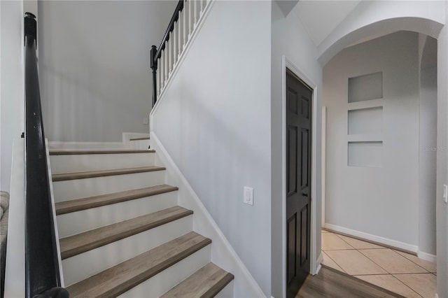 17809 Sandpine Trace Way, Tampa, FL 33647 - stairs featuring arched walkways, built in shelves, and baseboards