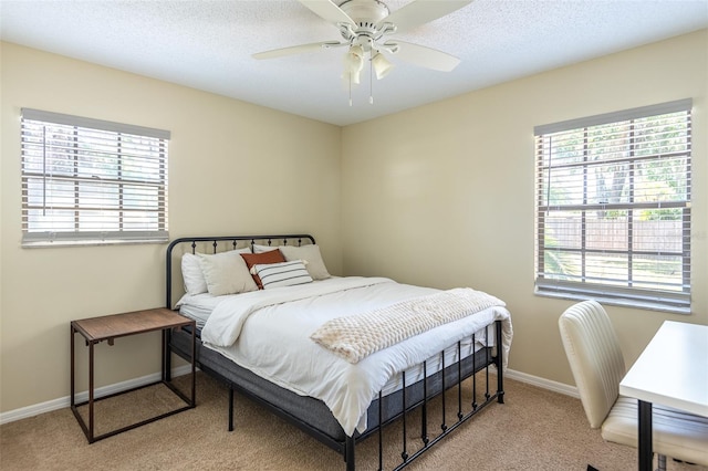 carpeted bedroom with baseboards and ceiling fan