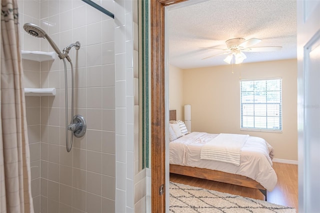 bedroom with wood finished floors, a textured ceiling, and ceiling fan