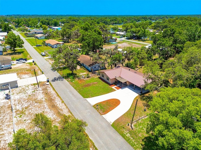 aerial view of residential area featuring a forest