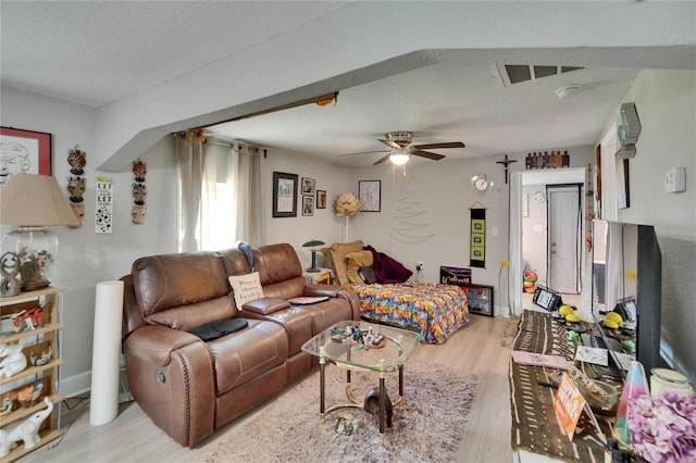 528 S Seminole Ave, Fort Meade, FL 33841 - living area featuring wood finished floors, a textured ceiling, and a ceiling fan