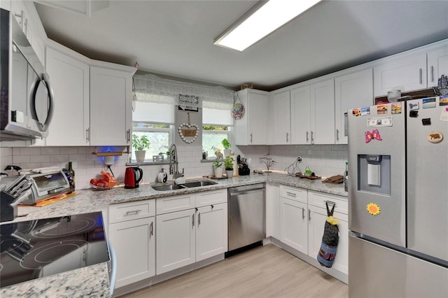528 S Seminole Ave, Fort Meade, FL 33841 - kitchen with appliances with stainless steel finishes, a sink, white cabinets, and decorative backsplash