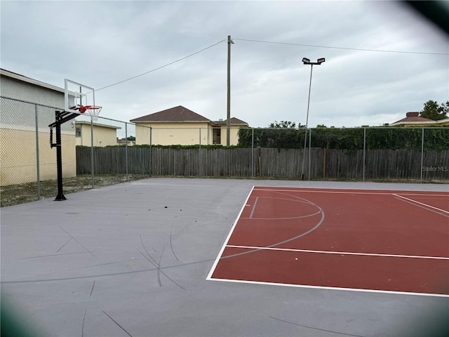 view of basketball court with basketball court and fence