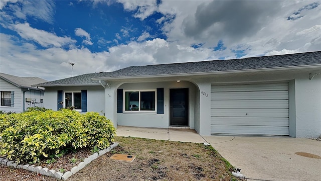 view of front of home featuring stucco siding, a garage, concrete driveway, and a shingled roof
