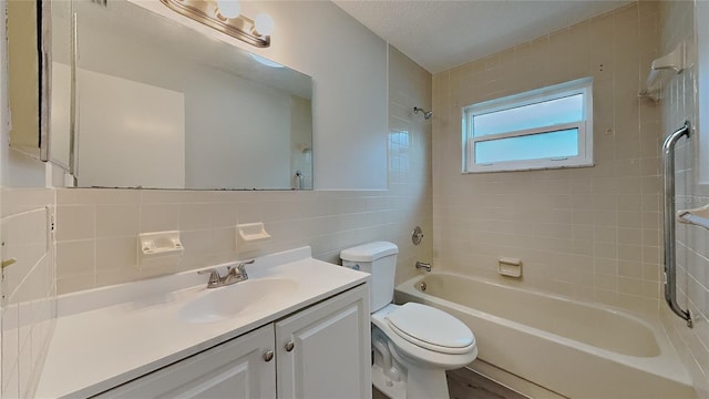bathroom with bathing tub / shower combination, toilet, vanity, and tile walls