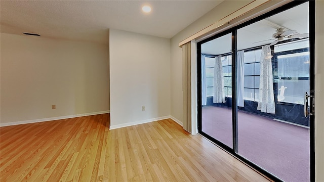 spare room with light wood finished floors and baseboards