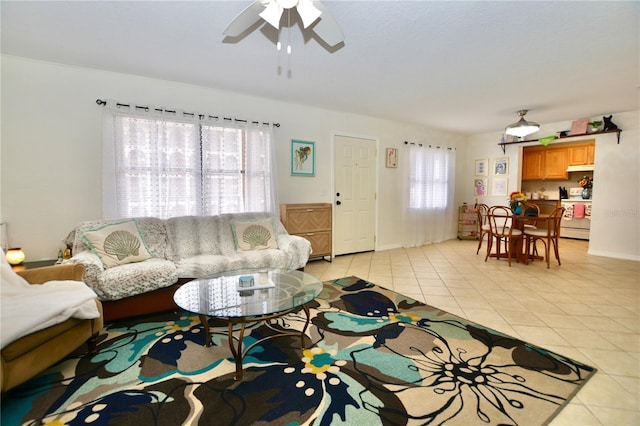 6150 Gulfport Blvd S Unit 302, Gulfport, FL 33707 - living room featuring light tile patterned floors, a ceiling fan, and baseboards
