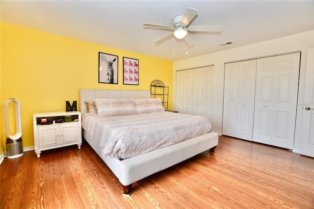 6150 Gulfport Blvd S Unit 302, Gulfport, FL 33707 - bedroom featuring multiple closets, wood finished floors, and a ceiling fan
