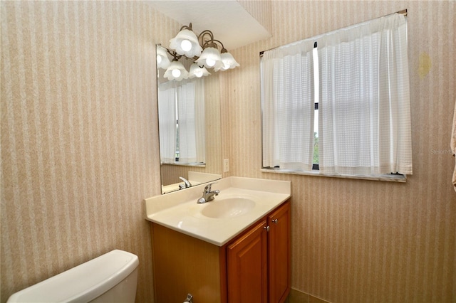 6150 Gulfport Blvd S Unit 302, Gulfport, FL 33707 - bathroom featuring wallpapered walls, vanity, and toilet