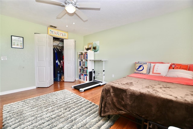 6150 Gulfport Blvd S Unit 302, Gulfport, FL 33707 - bedroom featuring wood finished floors, a ceiling fan, baseboards, and a closet
