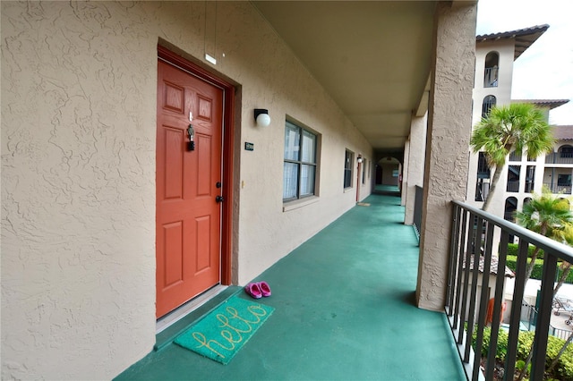 6150 Gulfport Blvd S Unit 302, Gulfport, FL 33707 - doorway to property with a balcony and stucco siding