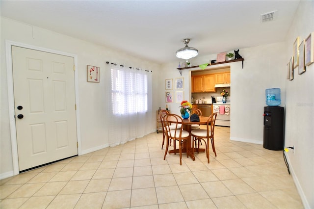 6150 Gulfport Blvd S Unit 302, Gulfport, FL 33707 - dining area with baseboards and light tile patterned floors