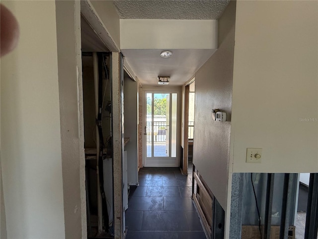 2621 Cove Cay Dr Unit 206, Clearwater, FL 33760 - hallway featuring a textured ceiling and a textured wall