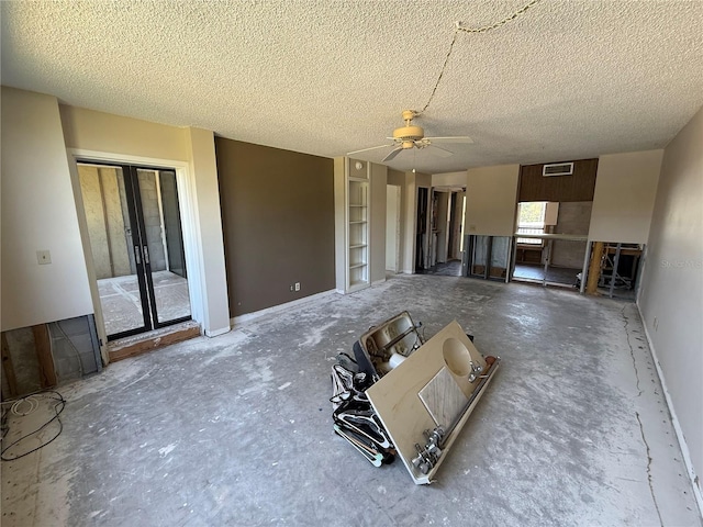 2621 Cove Cay Dr Unit 206, Clearwater, FL 33760 - unfurnished living room featuring ceiling fan, a textured ceiling, and baseboards