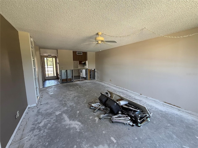 2621 Cove Cay Dr Unit 206, Clearwater, FL 33760 - unfurnished living room featuring a ceiling fan, a textured ceiling, and baseboards