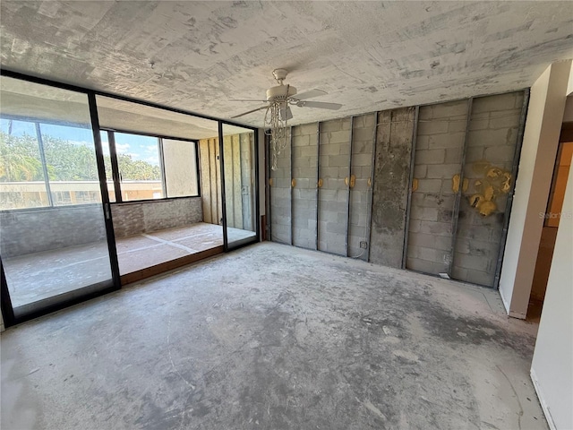 2621 Cove Cay Dr Unit 206, Clearwater, FL 33760 - unfurnished bedroom featuring access to exterior, concrete flooring, and a ceiling fan