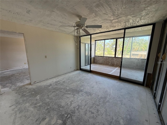 2621 Cove Cay Dr Unit 206, Clearwater, FL 33760 - unfurnished bedroom with access to exterior, concrete floors, and ceiling fan