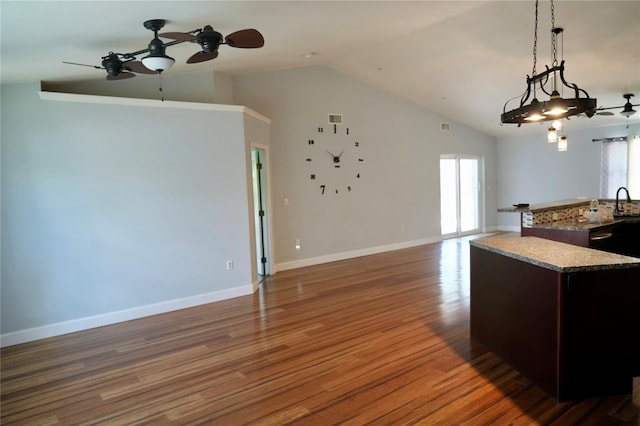 kitchen with a ceiling fan, healthy amount of natural light, open floor plan, and high vaulted ceiling