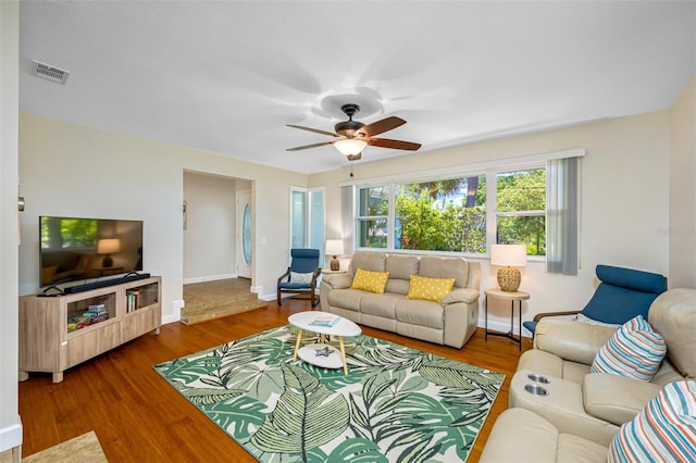 3749 Mckay Creek Dr, Largo, FL 33770 - living area featuring a ceiling fan, wood finished floors, and baseboards