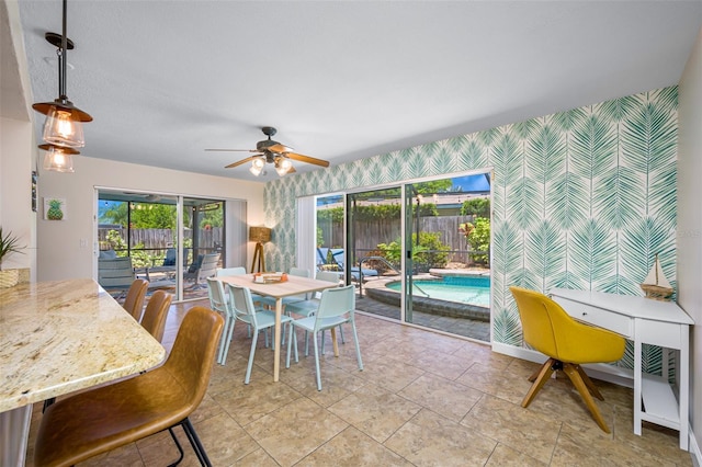 3749 Mckay Creek Dr, Largo, FL 33770 - dining area featuring wallpapered walls, an accent wall, and a ceiling fan