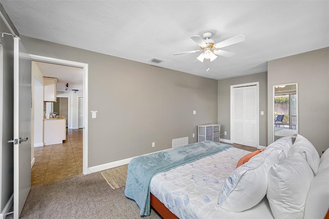 3749 Mckay Creek Dr, Largo, FL 33770 - carpeted bedroom featuring baseboards, a ceiling fan, a closet, and tile patterned floors