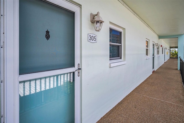 8 Glencoe Pl Unit 305, Dunedin, FL 34698 - view of exterior entry featuring stucco siding