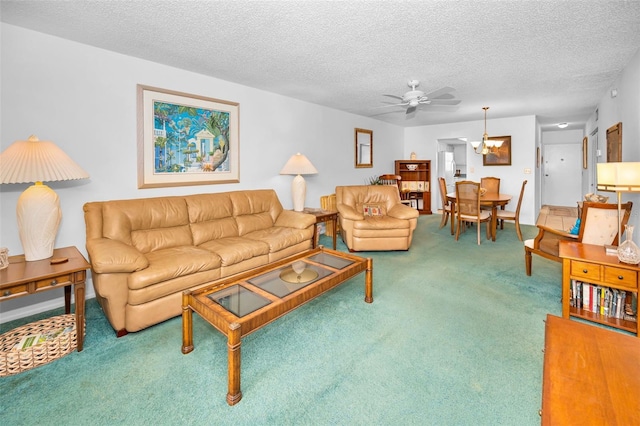 8 Glencoe Pl Unit 305, Dunedin, FL 34698 - living area with carpet flooring, ceiling fan, and a textured ceiling