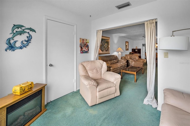 8 Glencoe Pl Unit 305, Dunedin, FL 34698 - carpeted living room featuring a textured ceiling