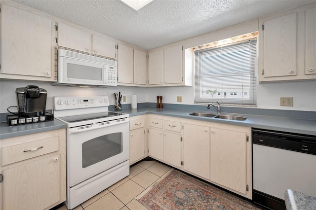 8 Glencoe Pl Unit 305, Dunedin, FL 34698 - kitchen with white appliances, a sink, a textured ceiling, and light tile patterned floors